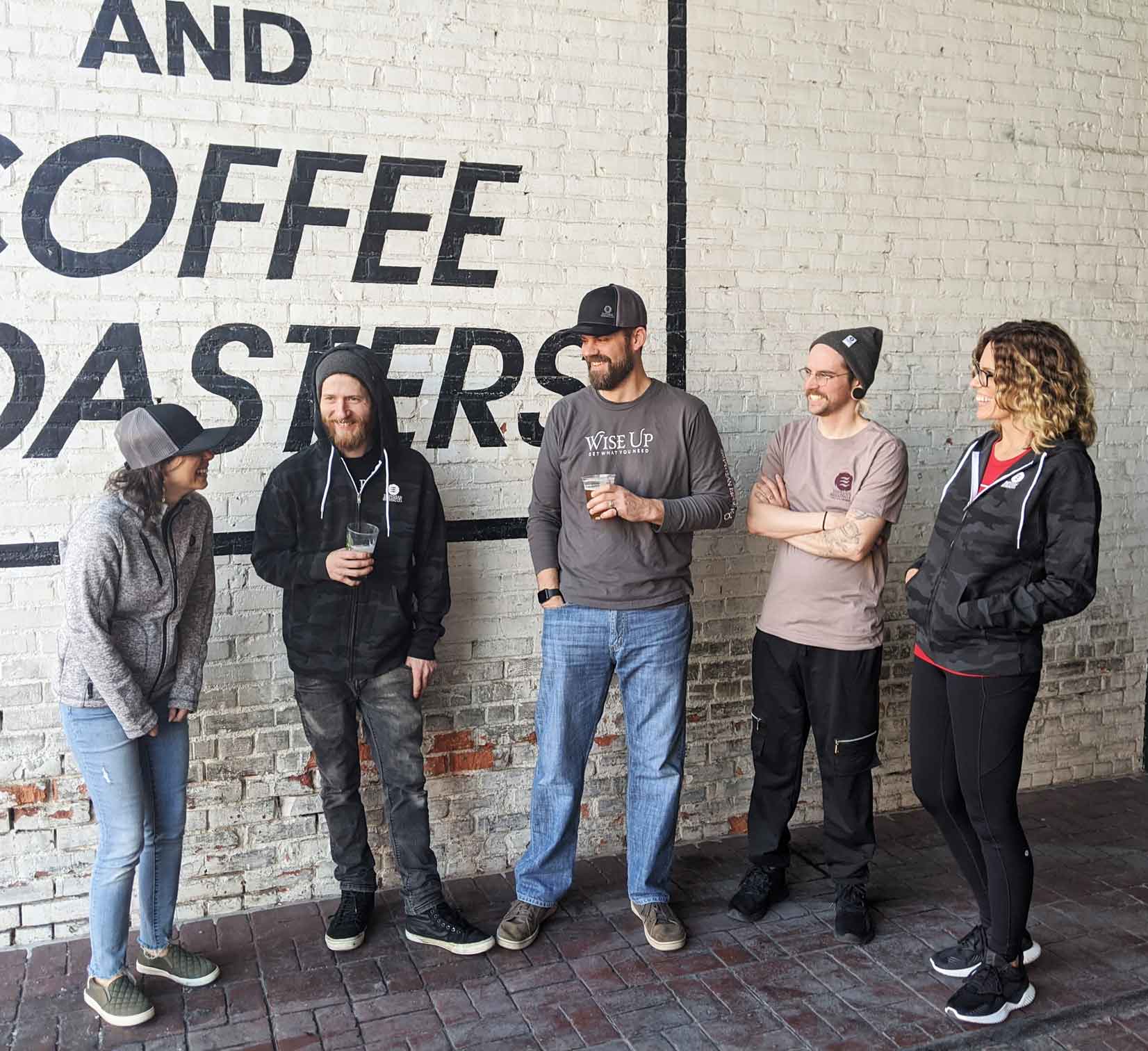 Empyrean Brewing Co. employees standing in front of the Coffee and Spice Building